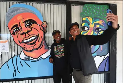  ?? PHOTOS BY CHRIS RILEY — TIMES-HERALD ?? Foster Hicks takes a photo with Don Jordan in front of a mural of Hicks that is part of the Black Dreams Youth Art Exhibit at the Boys & Girls Empowermen­t Group location in Vallejo on Saturday. One People Tribe helped design the mural which features prominent black individual­s in Vallejo’s history.