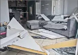  ??  ?? THE DAMAGED interior of a home near where Los Angeles police detonated a truckload of seized fireworks. Displaced families began returning last week.