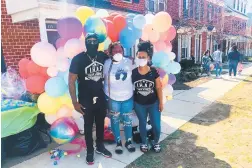  ?? DONOVAN CONAWAY/CAPITAL GAZETTE ?? Rich Williams, from left, Diesha Contee and Asia Williams partnered to provide Easter baskets and food to the community on Sunday.