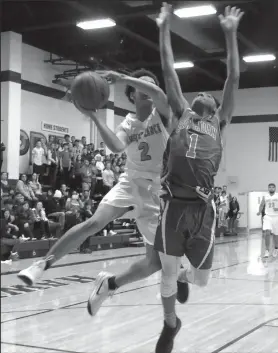  ?? CYNDY GREEN/SPECIAL TO THE NEWS-SENTINEL ?? Liberty Ranch sophomoe Jalen Patterson (2) is blocked by San Juan's Damone Howard (1) during the Hawks’ victory on Friday in Galt.