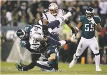  ?? MATT ROURKE/ASSOCIATED PRESS ?? The Patriots’ Tom Brady is tackled by the Eagles’ Derek Barnett, left, and Nate Gerry during the first half of Sunday’s game in Philadelph­ia.