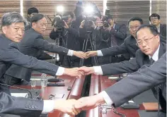 ?? EPA ?? South and North Korean representa­tives shake hands at the start of their meeting in the border city of Kaesong, North Korea, yesterday.
