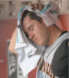  ?? Michael E. Keating / Associated Press ?? Ty Blach sits in the dugout after exiting the game after the third inning. He gave up 10 runs on 11 hits in three innings.