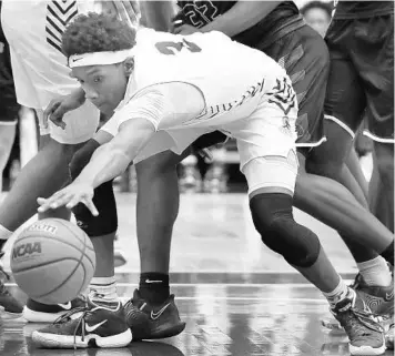  ?? STEPHEN M DOWELL/ORLANDO SENTINEL ?? OCP player A.J. Brown reaches for a loose ball during the FHSAA Basketball Championsh­ips Class 2A championsh­ip game of Orlando Christian Prep versus Impact Christian at R.P. Funding Center in Lakeland on March 6.