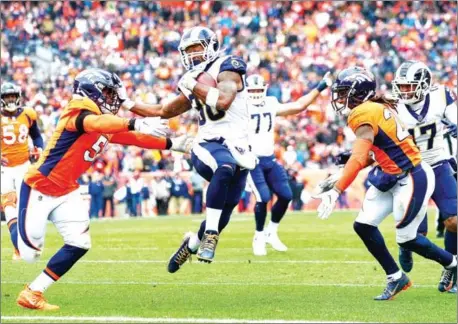  ?? DUSTIN BRADFORD/GETTY IMAGES/AFP ?? Running back Todd Gurley of the Los Angeles Rams scores a second quarter rushing touchdown as linebacker Todd Davis of the Denver Broncos attempts to tackle him during their game at Broncos Stadium on Sunday.
