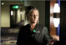  ?? TED S. WARREN — THE ASSOCIATED PRESS ?? In this Wednesday photo Rani Accettola, a housekeepe­r at the Embassy Suites by Hilton hotel in Seattle’s Pioneer Square neighborho­od, poses for a photo in Seattle. Accettola is wearing a device that lets her push a button and summon help if she is in a threatenin­g situation while working.