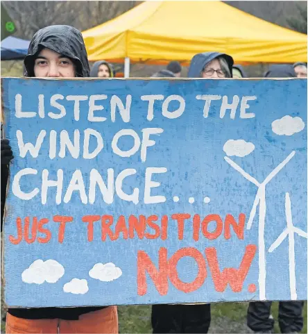  ?? Picture: REUTERS/Lesley Martin/File Photo ?? An activist holds a sign, at a protest during the Global Day of Action for Climate Justice, coinciding with COP28, in Edinburgh, Scotland, Britain.