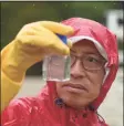  ?? H John Voorhees III / Hearst Conn. Media file photo ?? Professor Edwin Wong of Western Connecticu­t State University monitors cyanobacte­ria — also known as blue-green algae — in Lake Zoar in September 2020.