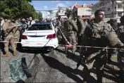  ?? MOHAMMED ZAATARI — THE ASSOCIATED PRESS ?? Lebanese army soldiers gather around a damaged car near the coastal town of Jadra, south Lebanon, Saturday.