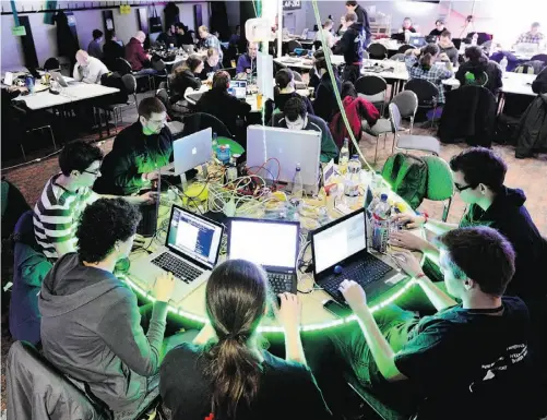  ?? Patrick Lux/ Getty Images ?? Participan­ts work at their laptops at the annual Chaos Computer Club (CCC) computer hackers’ congress in Germany on Thursday.