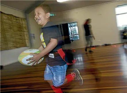  ?? WARWICK SMITH/STUFF ?? Namit Pradhan, 7, from Bhutan, takes to rippa rugby as part of a learn-to-play programme for refugee children.