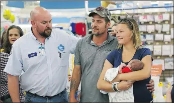  ?? — NORTHWEST FLORIDA DAILY NEWS VIA AP ?? Nick Davis, left, meets with Wilmer Capps, and his wife, Lorrainda, and their son Luke, at a Walmart in Panama City Beach, Fla., yesterday.