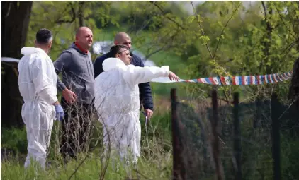  ?? ?? Forensic police inspects the scene around a car in the village of Dubona, some 50 kilometers (30 miles) south of Belgrade, Serbia, Friday, May 5, 2023. A shooter killed multiple people and wounded more in a drive-by attack late Thursday in Serbia's second such mass killing in two days, state television reported. Photo: AP/Armin Durgut.