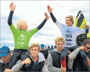  ?? Picture: SUPPLIED ?? HIGH AND MIGHTY: Mitch du Preez, right, and Daniel Emslie are hoisted up after they finished first and second respective­ly in the U14 division of the SA junior champs held in Jeffrey's Bay at the weekend