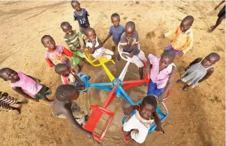  ??  ?? South Sudanese refugee children play on a merry-go-round at the Ombechi kindergart­en in the Bidi Bidi refugee settlement, northern Uganda, earlier this month. (AP)