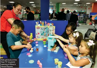  ?? ?? Kids get busy at the Toys "R" Us grand opening at Macy's Herald Square.