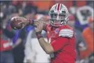  ?? RICK SCUTERI - THE ASSOCIATED PRESS ?? FILE - In this Dec. 28, 2019, file photo, Ohio State quarterbac­k Justin Fields throws a pass against Clemson during the first half of the Fiesta Bowl NCAA college football playoff semifinal in Glendale, Ariz. When Fields got together with some of his teammates last Saturday to watch college football on TV, the mood was dark. “Distraught,” Fields said.