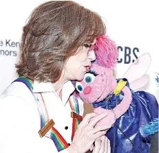  ?? — AFP photo ?? Fields gives Sesame Street character Abby Cadabby a hug and a kiss at the 2019 Kennedy Centre Honours at The Kennedy Centre in Washington, DC.