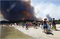  ?? PICTURE: AP ?? GAME CHANGER: Sunbathers are evacuated from the beach in Le Lavandou, French Riviera, as plumes of smoke rise in the air from wildfires.