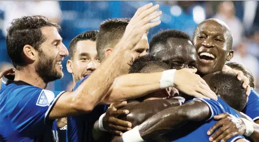  ?? GRAHAM HUGHES/FILES ?? Impact players celebrate a goal by Bacary Sagna against the New York Red Bulls last September. The club’s season got off to a disappoint­ing start in 2018.