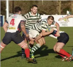  ??  ?? Andrew Kealy is lifted in a tackle against Malone.