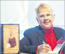  ?? AP FILE PHOTO ?? Peggy Sue Gerron unveils her new book “Whatever Happened to Peggy Sue” during a news conference in Tyler, Texas, in January 2008.