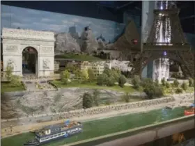  ?? MARY ALTAFFER — THE ASSOCIATED PRESS ?? The Seine river, the Champs-Elysees, and the Eiffel Tower are depicted in the Europe section of the Gulliver’s Gate exhibit, Wednesday in New York. The indoor 49,000-squarefoot diorama includes scale models of structures and landscapes from the...