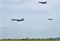  ?? AP-Yonhap ?? A U.S. Air Force B-1B bomber, left, flies with South Korean F-15K fighters over Osan Air Base in Pyeongtaek, Gyeonggi Province, Sunday. The U.S. flew two supersonic bombers over the Korean Peninsula in a show of force against North Korea following its...