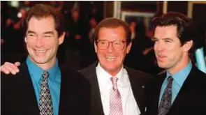  ??  ?? In this Sunday, Nov 17, 1996 file photo, three of the actors who played James Bond, Timothy Dalton left, Roger Moore, center, and Pierce Brosnan, at a London cinema to celebrate the life of Albert R. "Cubby" Broccoli, the American film producer behind...