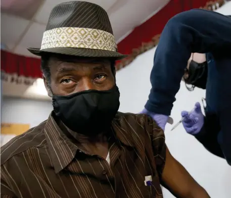  ?? NAncy lAnE / HErAld stAFF FilE ?? GOT THE J&J SHOT: Fritzner Filoma, 70, receives the Johnson & Johnson vaccine as the Whittier Street Health Center delivers shots at the Haitian Americans United Nazarene Church on April 7.