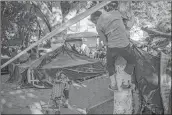  ??  ?? Central American migrants wanting to reach the US, remain at a temporary shelter in Tijuana, Mexico on Tuesday.