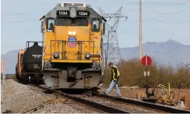  ?? Photograph: David Boe/AP ?? Crew on a Union Pacific freight train works at a siding area on January 2020, south of Tucson, Arizona.