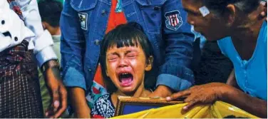  ?? Agence France-presse ?? ↑
Daughter of a protester, who was killed during a demonstrat­ion, cries during his funeral in Yangon on Friday.