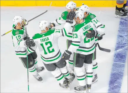  ?? Jason Franson The Associated Press ?? Dallas’ Blake Comeau (15), Radek Faksa (12), Esa Lindell (23), Jamie Benn (14) and John Klingberg (3) celebrate Klingberg’s goal against the Golden Knights in the first period of Game 1. That proved to be the only scoring in the Stars 1-0 win on Sunday.