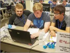  ?? SUBMITTED PHOTO ?? Coatesvill­e Area Senior High students Mitchell Henderson, Nathaniel Bream and Josh Ramos work together. They earned first place in their division of the Code Quest, a computer coding competitio­n.