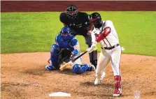  ?? SUE OGROCKI/ASSOCIATED PRESS ?? Atlanta’s Marcell Ozuna connects for his second home run of the game Thursday in the Braves’ Game 4 rout of Los Angeles in Arlington, Texas.