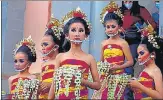  ?? AP ?? Dancers, wearing shields to help curb the spread of Covid-19, prepare for a performanc­e at a festival in Bali, Indonesia.