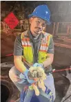  ?? San Antonio Water System ?? A San Antonio Water System employee holds a puppy that was rescued from a sewer line Wednesday night on Brunswick Boulevard.