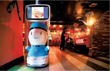 ?? MIKE STOCKER/SOUTH FLORIDA SUN SENTINEL ?? Mr. Q Crab House, a Hollywood seafood restaurant, uses robots to greet customers and for touchless, distanced ordering. A robot on wheels greets patrons as they enter the dining room.