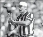  ?? File photo by George Rose, Getty Images ?? Official view: Jim Tunney, working a 1990 game, said replacemen­t referees will hurt the NFL.