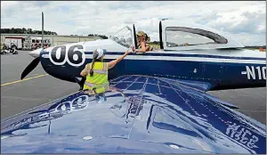  ?? Special to the Democrat-Gazette/JIMMY JONES ?? Martha Molina of Fayettevil­le, the Arkansas chairman of the Internatio­nal Associatio­n of Women Pilots (Ninety-Nines), hands a bottle of water up to 2019 Air Classic Racer Ailsa Moseley Cutting of Wellington, Fla., during a stop at Saline County airport in Bryant. More photos are available at arkansason­line.com/619aviator­s/.