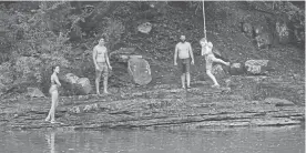  ?? Adam Ewing, for The Washington Post ?? A family hangs out at the water’s edge near the Big Bend Campground in Cabins, W.VA.