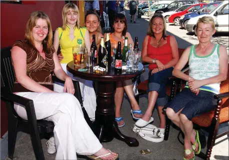  ?? Photo by John Reidy ?? Enjoying the fine weather outside Michael Burke’s Bar on Castleisla­nd’s Main Street on a Friday afternoon in 2006 were, from left: Mary and Catheriona O’Brien, Sheila Brosnan, Kay Galvin, Geraldine Brosnan and Kay O’Brien. Castleisla­nd’s proposed new look will feature street furniture to cater for scenes like this but with more social distancing and a hope for fine weather.