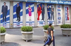  ?? TED SHAFFREY — ASSOCIATED PRESS FILE PHOTO ?? Images of Fox News personalit­ies, from left, Tucker Carlson, Sean Hannity, Laura Ingraham, Maria Bartiromo, Stuart Varney, Neil Cavuto and Charles Payne appear outside News Corporatio­n headquarte­rs in New York on July 31, 2021. In defending itself against a massive defamation lawsuit over how Fox covered false claims surroundin­g the 2020presid­ential election, the network is relying on a 1964Suprem­e Court ruling that makes it difficult to successful­ly sue media organizati­ons for libel.