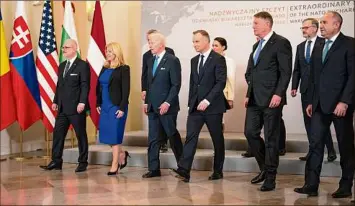  ?? Doug Mills / New York Times ?? President Joe Biden, third from left, walks with leaders from NATO’S eastern flank Wednesday in Warsaw. The meeting was another display of trans-atlantic unity against Russia while President Vladimir Putin warmly welcomed China’s top diplomat to Moscow.