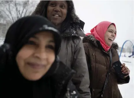  ?? PETER POWER FOR THE TORONTO STAR ?? Sabina Ali, right, laughs with friends while volunteeri­ng at the Thorncliff­e Park Winter Carnival.“I love this community and I wanted to get involved. I knew this was the place to start,” she says. A United Way poll shows 95 per cent of respondent­s...