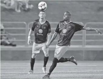  ?? STAFF PHOTO BY C.B. SCHMELTER ?? Chattanoog­a FC’s Everson Lima, right, eyes the ball during a playoff game against the Atlanta Silverback­s in July at Finley Stadium. CFC, a 10-year-old club, might soon make the switch from amateur to pro competitio­n.