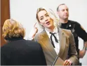  ?? STEVE HELBER AP ?? Actor Amber Heard talks to her attorney, Elaine Bredehoft, in the courtroom Monday before leaving for the day. The libel trial is now in its sixth week.