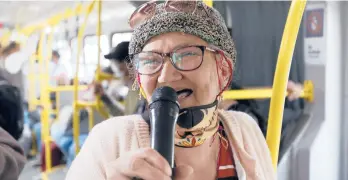  ?? VERGARA/AP FERNANDO ?? Marlene Alfonso, who goes by “Toothless Cindy,”sings Nov. 3 on the Transmilen­io bus in Bogota.