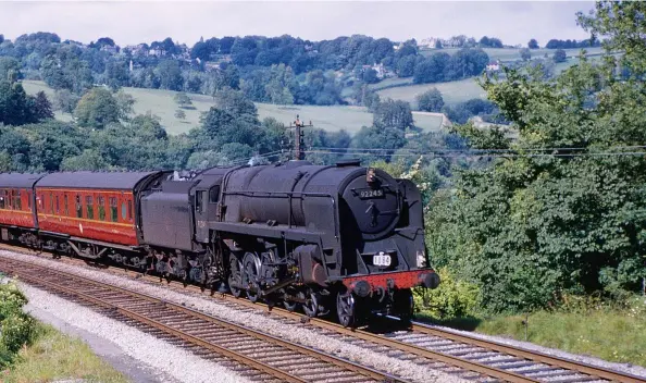  ?? R C Riley ?? LMS ‘2P’ 4-4-0 No 40564 pilots BR Standard ‘5MT’ No 73052 on the 1 in 53 grade as they near Chilcompto­n tunnel with 1O94, the 7.45am from Bradford (Forster Square) to Bournemout­h (West) on 1 July 1961. This was to be the last year for the venerable ‘2Ps’ which had had been a fixture of the line since Midland Railway days and a mainstay on passenger and train pilot duties. The S&D suffered a long game of ‘pass the parcel’ in the BR era with regional boundary and operating department changes. The line found itself split between the Western and Southern regions but with locomotive­s borrowed from the London Midland Region, a situation that would inevitably change. New BR Standard ‘5MT’ 4-6-0s were introduced at Bath in April 1954, displacing LMS ‘5MT’ 4-6-0s back to the LMR, but many LMS types would endure well into the 1960s, notably the Fowler ‘4F’ 0-6-0s and ‘2P’ 4-4-0s on goods and passenger duties.